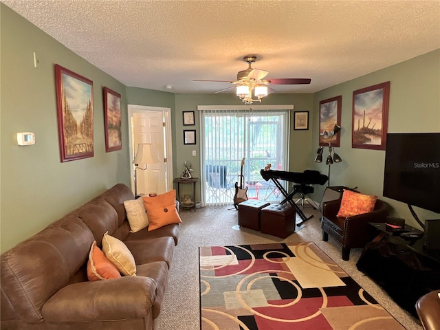 living area with carpet floors, a ceiling fan, and a textured ceiling