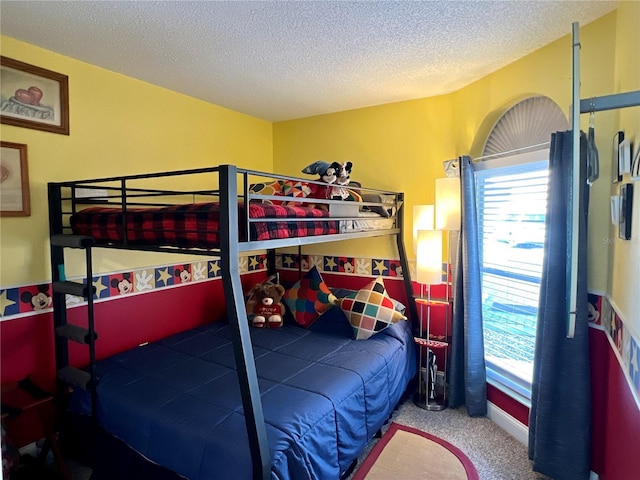 carpeted bedroom featuring a textured ceiling