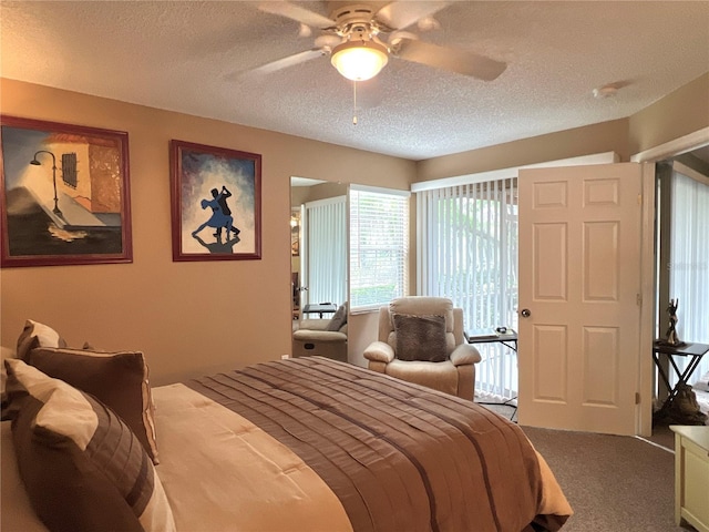 bedroom featuring a textured ceiling, carpet floors, and ceiling fan