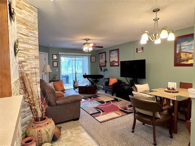 living room with a textured ceiling and ceiling fan with notable chandelier