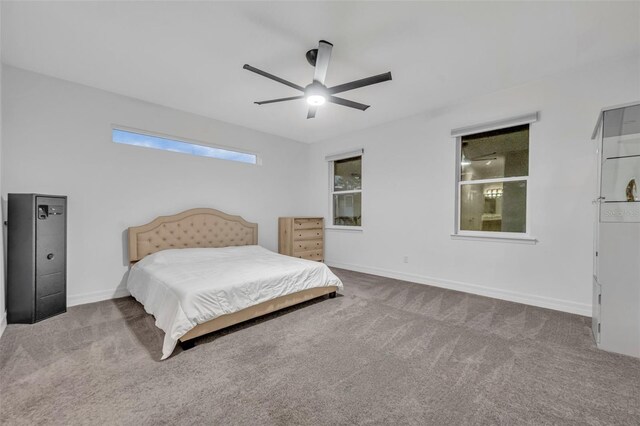 carpeted bedroom featuring ceiling fan and baseboards