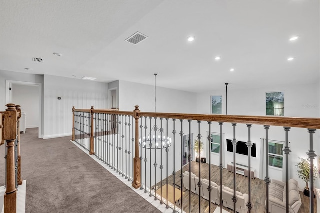 hall featuring carpet, visible vents, a chandelier, and recessed lighting