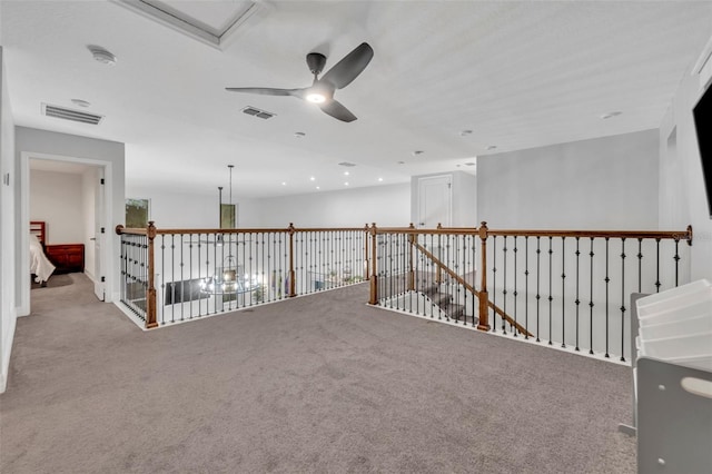 corridor featuring carpet, an upstairs landing, and visible vents