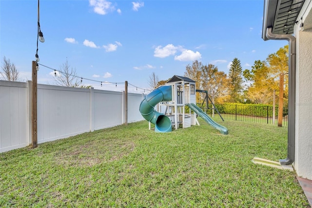 view of playground featuring a fenced backyard and a yard