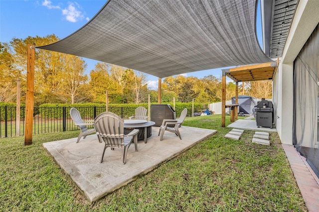 view of yard featuring a fenced backyard, a fire pit, and a patio