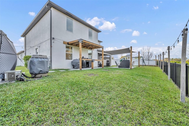 rear view of house with a lawn, a patio, a fenced backyard, ac unit, and stucco siding