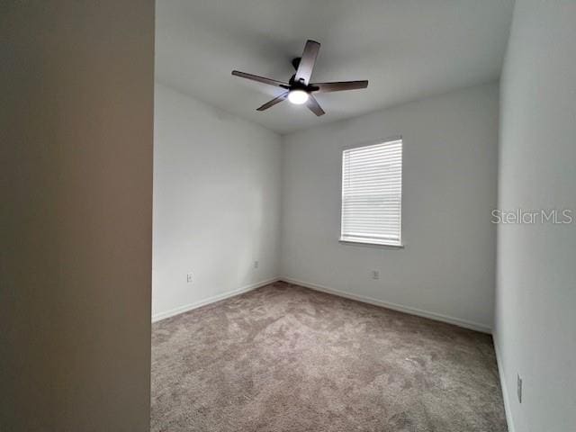 unfurnished room featuring ceiling fan, carpet floors, and baseboards