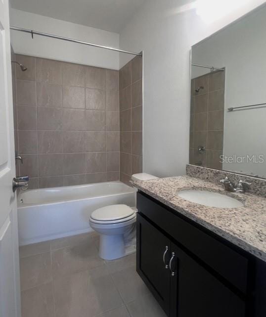 bathroom featuring shower / bath combination, vanity, toilet, and tile patterned floors