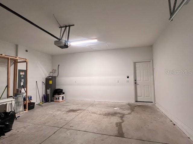 garage with water heater, baseboards, and a garage door opener