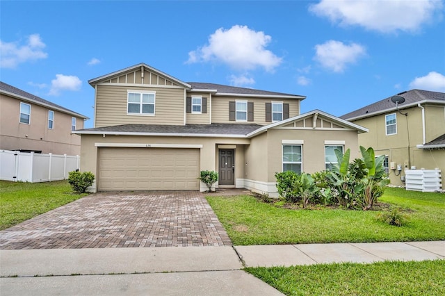 view of front of house featuring a front yard, fence, stucco siding, a garage, and decorative driveway