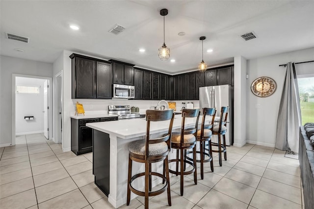 kitchen with light tile patterned floors, visible vents, and appliances with stainless steel finishes