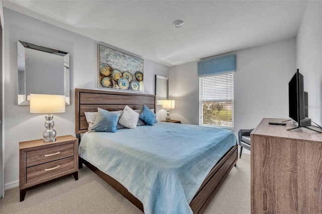 carpeted bedroom with baseboards and a textured ceiling