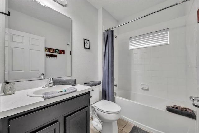 full bathroom with tile patterned flooring, toilet, shower / bath combo, a textured wall, and vanity