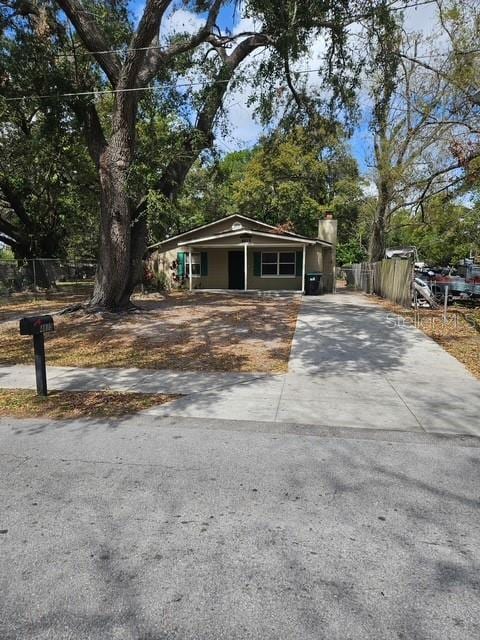 view of front of home featuring driveway and fence