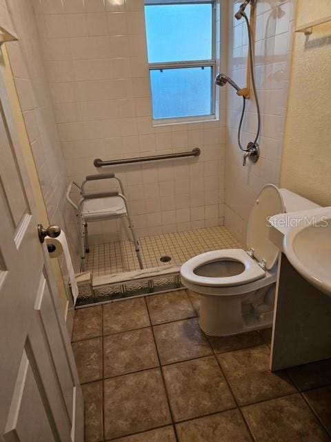 full bath with toilet, a shower stall, tile patterned flooring, and vanity