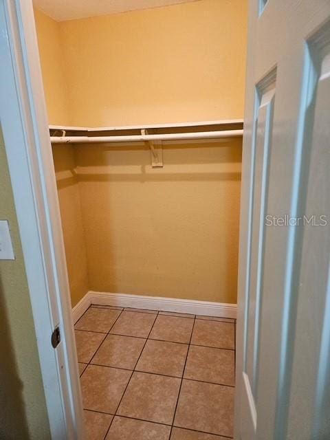 spacious closet with tile patterned floors