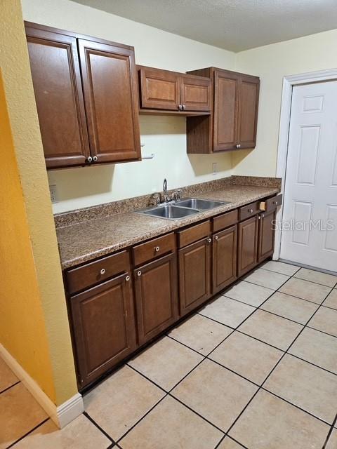 kitchen featuring a sink and light tile patterned floors