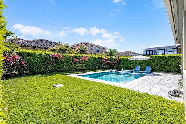 view of pool with a patio area and a yard