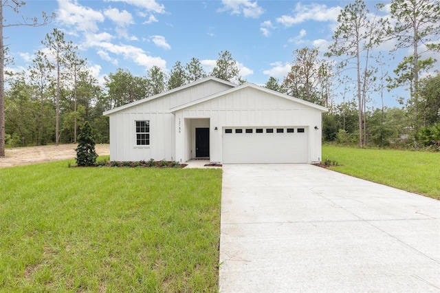 view of front facade with driveway, a front lawn, board and batten siding, and an attached garage