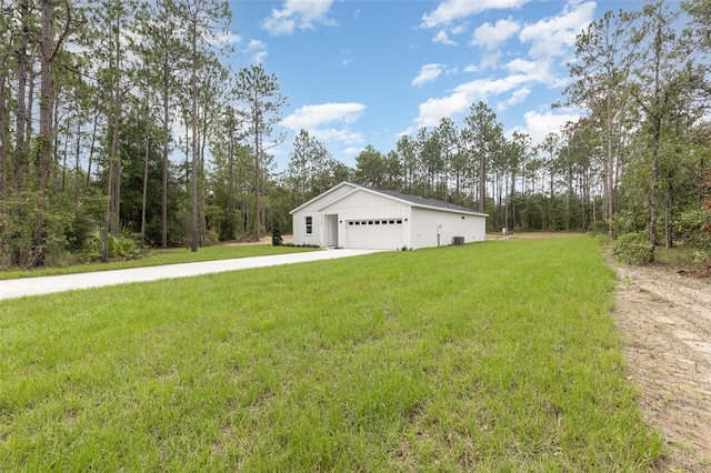 view of side of property with driveway and a yard