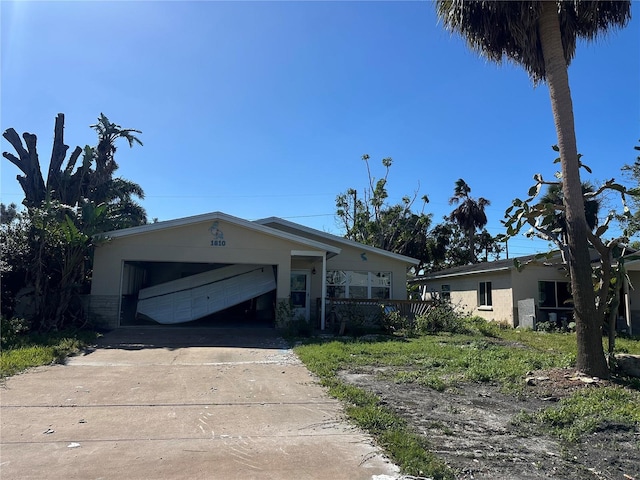 view of front of home with an attached garage, concrete driveway, and stucco siding