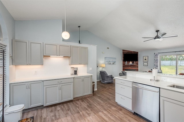 kitchen with light wood-type flooring, gray cabinets, dishwasher, and open floor plan