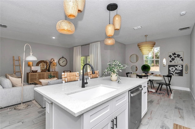 12639 SW 78th Pl, Dunnellon, FL 34432 - kitchen featuring a sink, dishwasher, hanging light fixtures, white cabinets, and open floor plan
