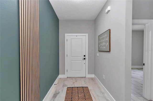12639 SW 78th Pl, Dunnellon, FL 34432 - doorway with a textured ceiling, light wood-type flooring, and baseboards