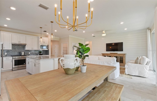 dining room with ornamental molding, visible vents, and recessed lighting