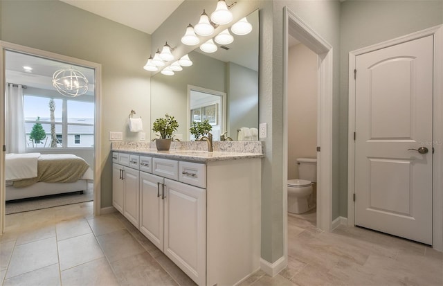 full bathroom with baseboards, toilet, ensuite bath, tile patterned floors, and vanity