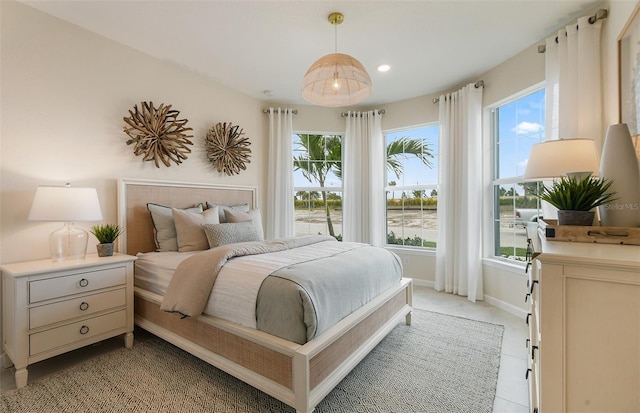 bedroom featuring recessed lighting, multiple windows, and baseboards