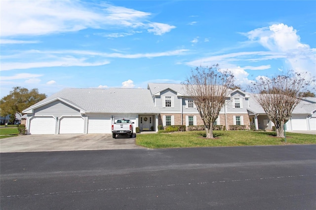 view of front facade with an attached garage, brick siding, concrete driveway, a residential view, and a front lawn