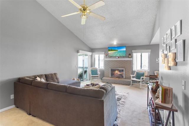 living area with a brick fireplace, light colored carpet, ceiling fan, and a textured ceiling