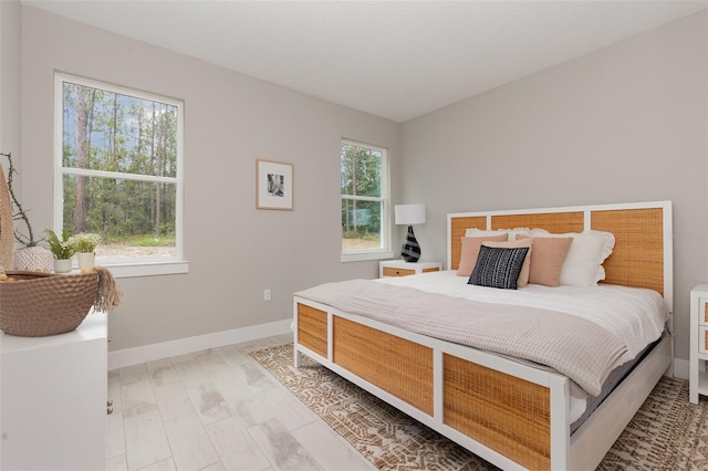 bedroom with multiple windows and baseboards