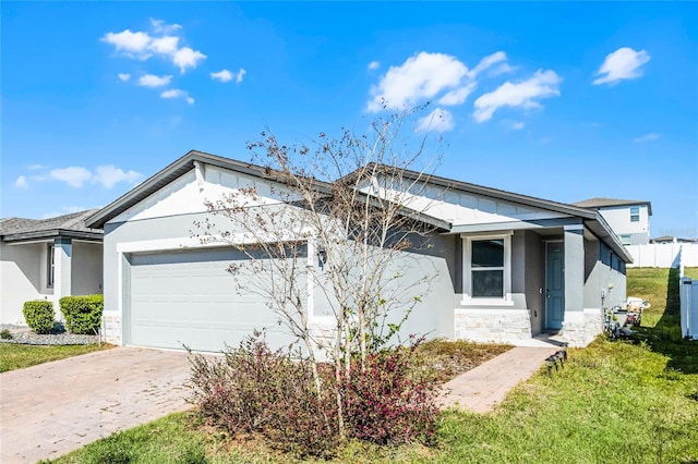 ranch-style home featuring driveway, an attached garage, a front lawn, and stucco siding