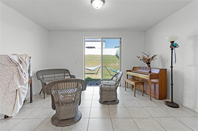 living area featuring light tile patterned floors and baseboards