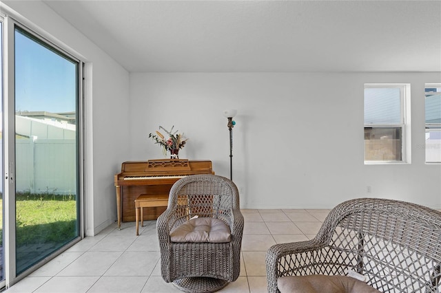 living area featuring light tile patterned flooring and baseboards