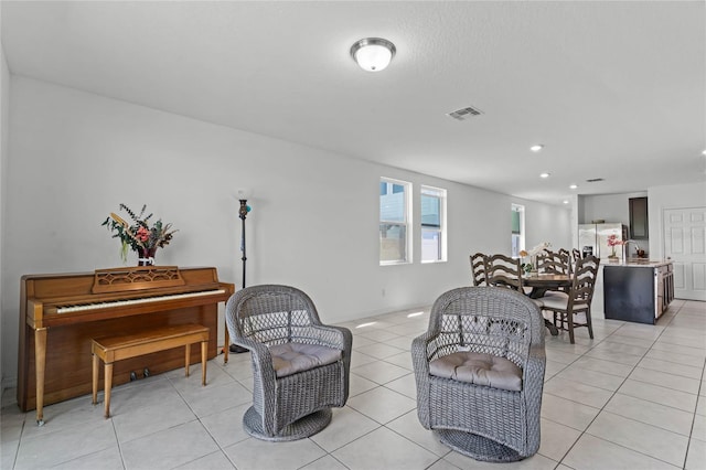 living room with light tile patterned floors and visible vents