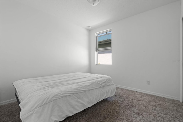 carpeted bedroom featuring baseboards