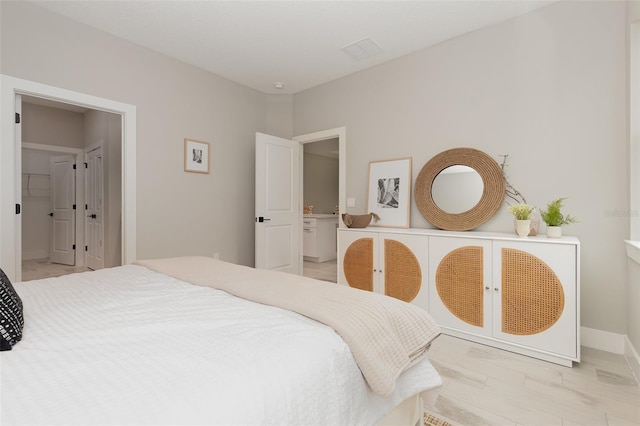 bedroom featuring visible vents and baseboards