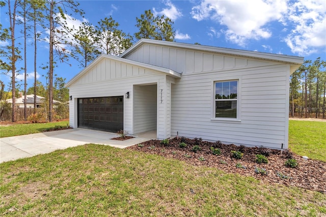 7117 SW 131st Ave, Ocala, FL 34481 - view of front facade with board and batten siding, a garage, concrete driveway, and a front yard