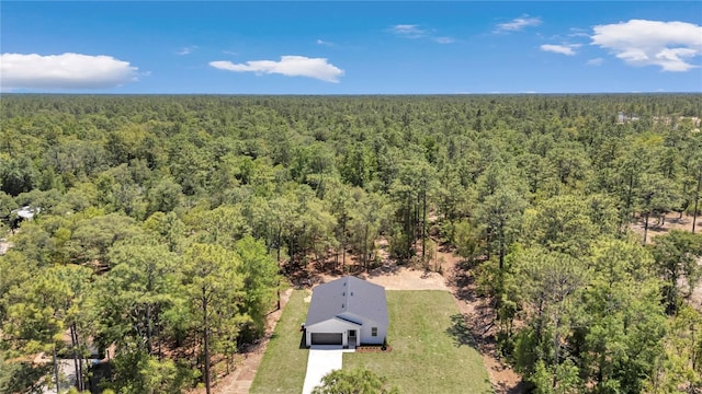 birds eye view of property with a view of trees