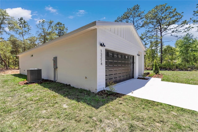 view of home's exterior with a yard, cooling unit, an outbuilding, and stucco siding