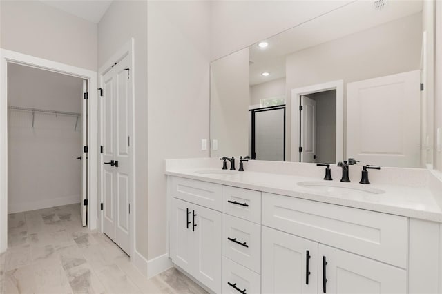13274 SW 82nd Ln, Dunnellon, FL 34432 - bathroom featuring a stall shower, double vanity, a walk in closet, baseboards, and recessed lighting