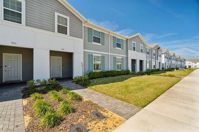 view of property featuring a residential view and a front yard