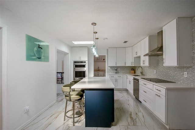 kitchen with tasteful backsplash, marble finish floor, stainless steel appliances, wall chimney range hood, and white cabinetry