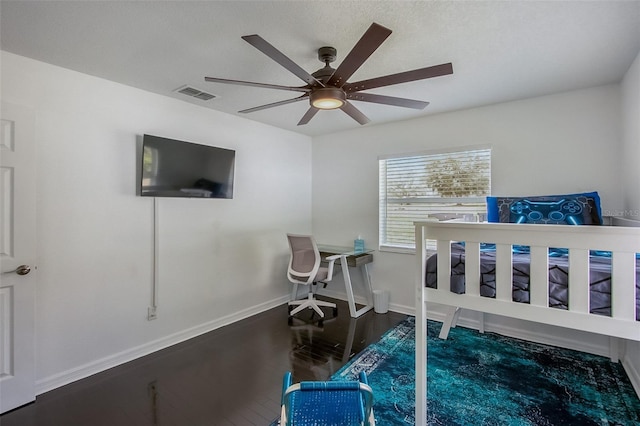 bedroom featuring ceiling fan, wood finished floors, visible vents, and baseboards