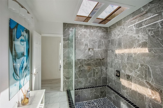 bathroom featuring marble finish floor and tiled shower