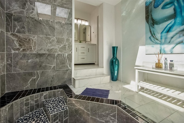 full bathroom with marble finish floor and vanity