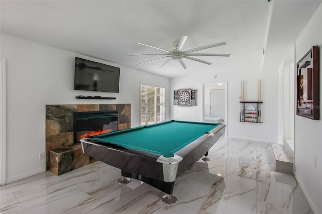 playroom featuring billiards, baseboards, a ceiling fan, a glass covered fireplace, and marble finish floor